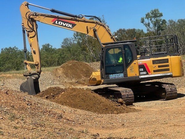 Yellow Lovol Excavator Digging Dirt on a Sunny Day — Huntlys Heavy Equipment in Gladstone, QLD