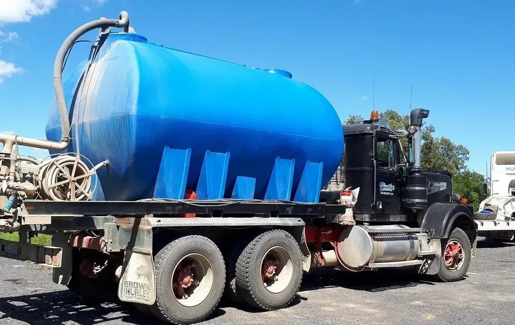 Blue Tank Truck Parked Outdoors on a Sunny Day — Huntlys Heavy Equipment In Gracemere, QLD
