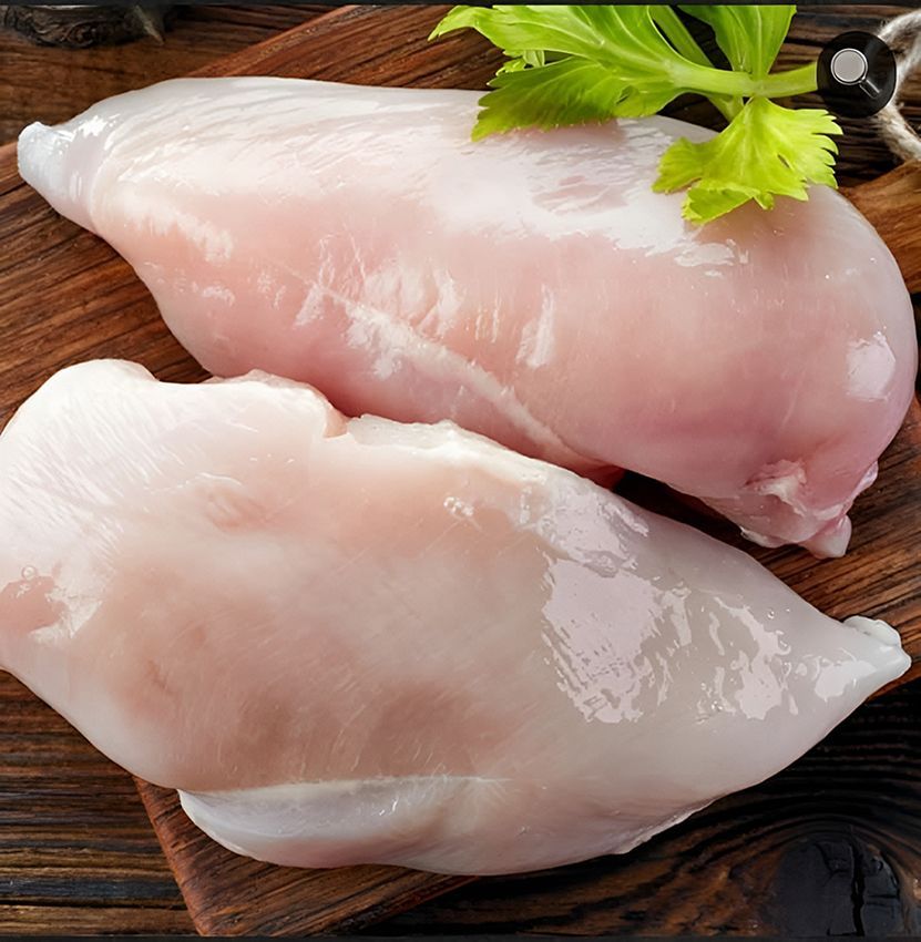 Two Chicken Breasts on a Wooden Cutting Board — Midway Butchers in Innisfail, QLD