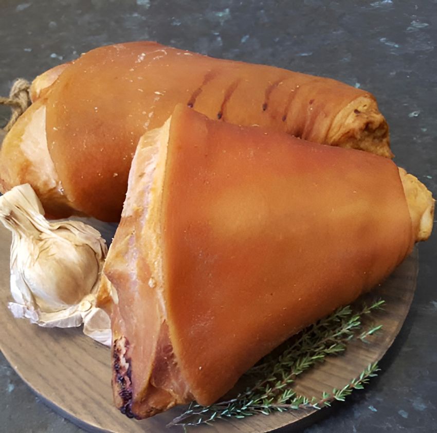 Two Pieces of Meat on a Wooden Cutting Board Next to Garlic — Midway Butchers in South Innisfail, QLD