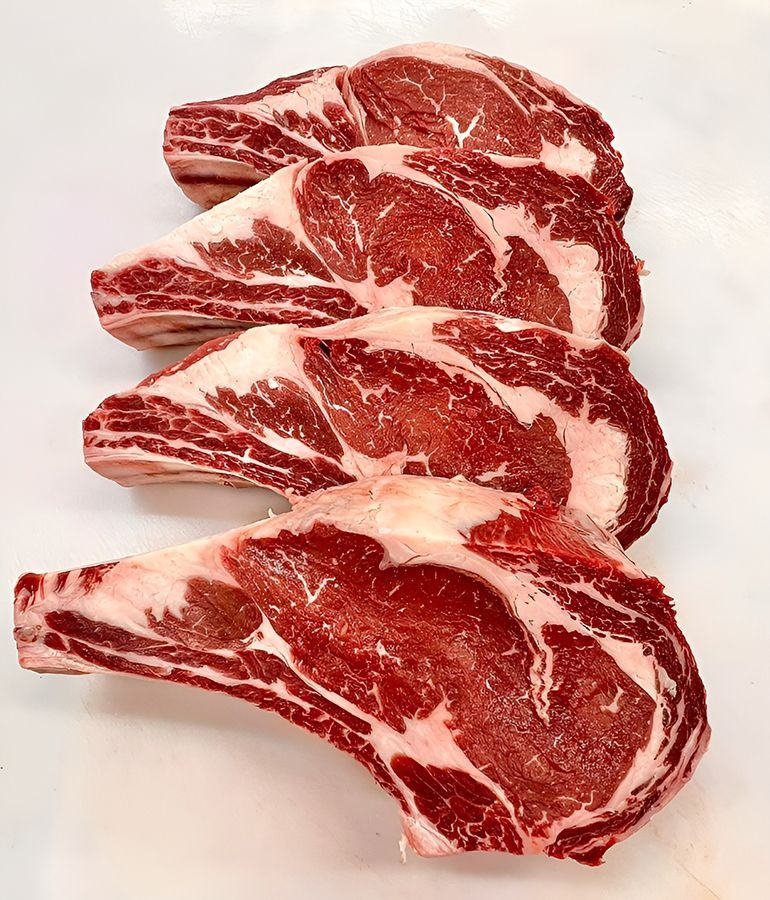 Four Raw Steaks Are Stacked on Top of Each Other — Midway Butchers in Mission Beach, QLD