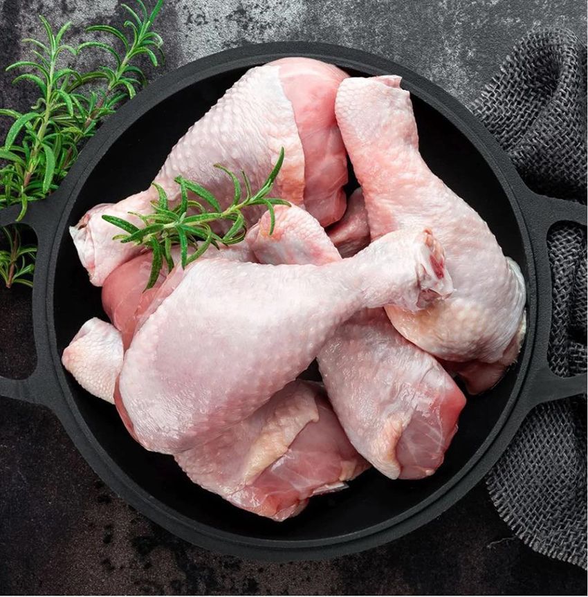 Raw Chicken Legs in a Pan with Rosemary on a Table — Midway Butchers in Innisfail, QLD