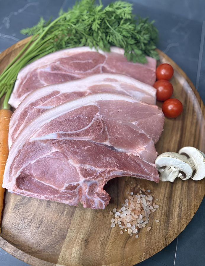 A Wooden Plate Topped with Meat, Vegetables and Spices — Midway Butchers in Tully, QLD