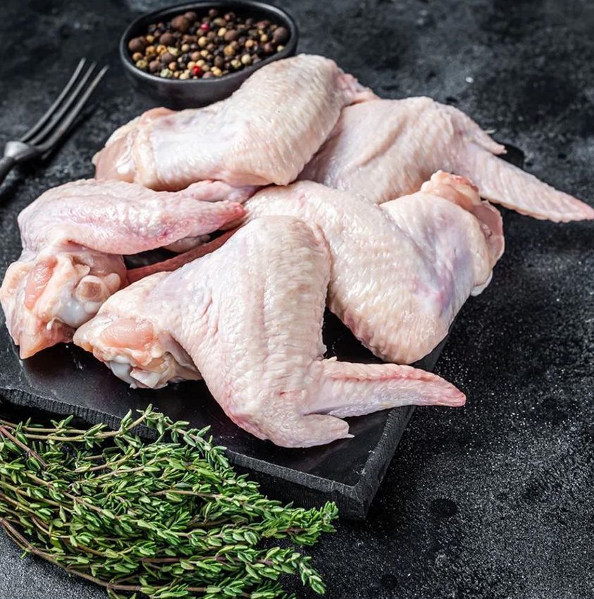 Raw Chicken Wings on a Cutting Board with Thyme and Pepper — Midway Butchers in South Innisfail, QLD