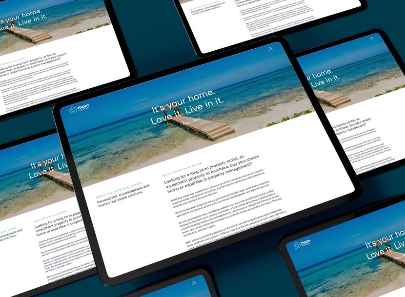 Tablets displaying a website with a blue and purple abstract design. 