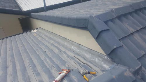 A Close Up of a Roof With a Hose and Pliers on It — Roofing Revamped in Maroochydore, QLD