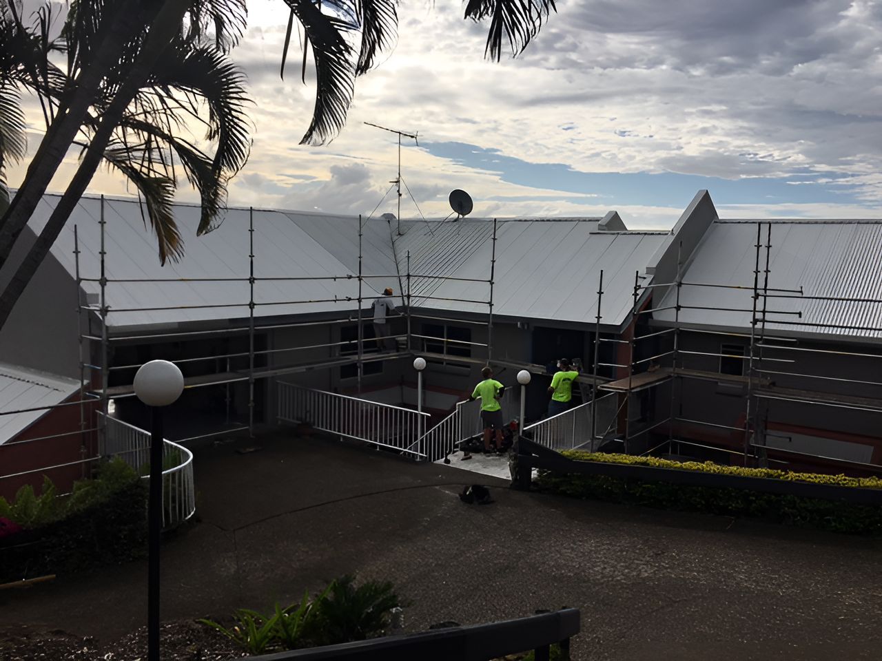 A Group of People Are Working on the Roof of a Building — Roofing Revamped in Wurtulla, QLD