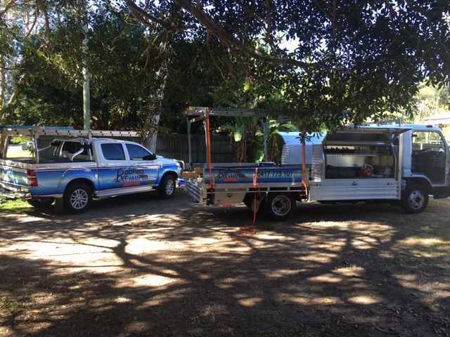 Two Trucks Are Parked Next to Each Other in a Parking Lot — Roofing Revamped In Maroochydore, QLD