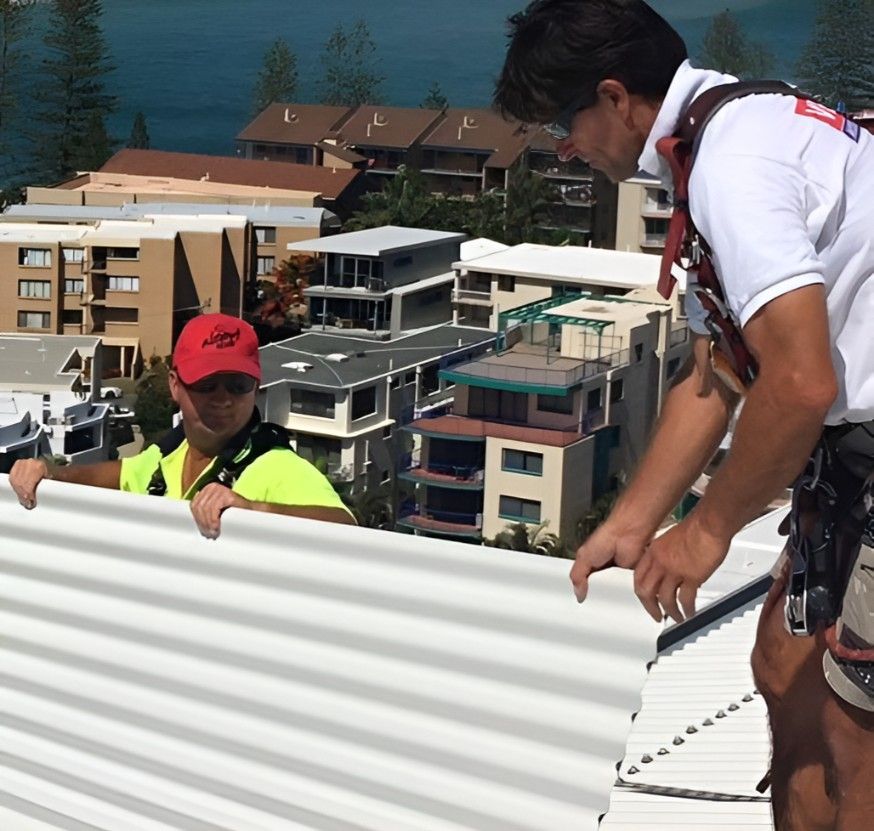 Two Men Carrying A Roof Tile — Roofing Revamped in Wurtulla, QLD