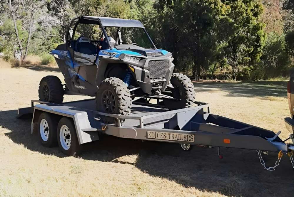A Polaris Rzr Is Sitting On Top Of A Trailer — Eddies Trailers & Fab in Muswellbrook, NSW
