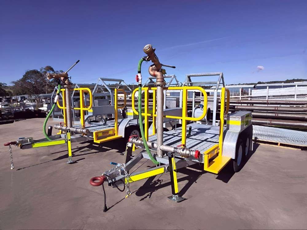 Two Trailers Are Parked Next To Each Other In A Parking Lot — Eddies Trailers & Fab in Muswellbrook, NSW