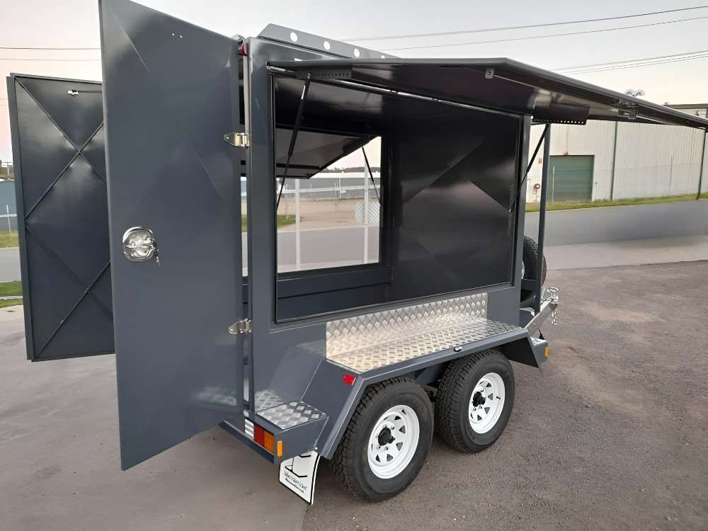 A Trailer With The Doors Open Is Parked On The Side Of The Road — Eddies Trailers & Fab in Muswellbrook, NSW