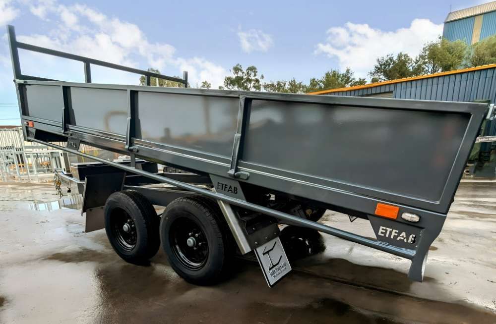 A Dump Trailer Is Parked In A Parking Lot In Front Of A Building — Eddies Trailers & Fab in Muswellbrook, NSW