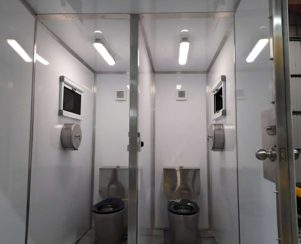 A Bathroom With Two Toilets And A Tv On The Wall — Eddies Trailers & Fab in Muswellbrook, NSW