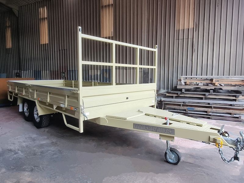 A Yellow Trailer Is Parked in Front of A Building — Eddies Trailers & Fab in Central Coast, NSW