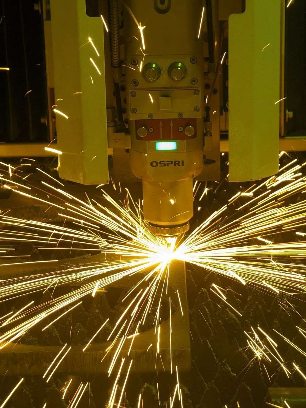 A Machine Is Cutting A Piece Of Metal With Sparks Coming Out Of It — Eddies Trailers & Fab in Muswellbrook, NSW