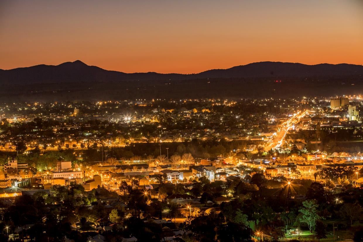 An Aerial View of A City at Night with Mountains in The Background — Eddies Trailers & Fab in Tamworth, NSW