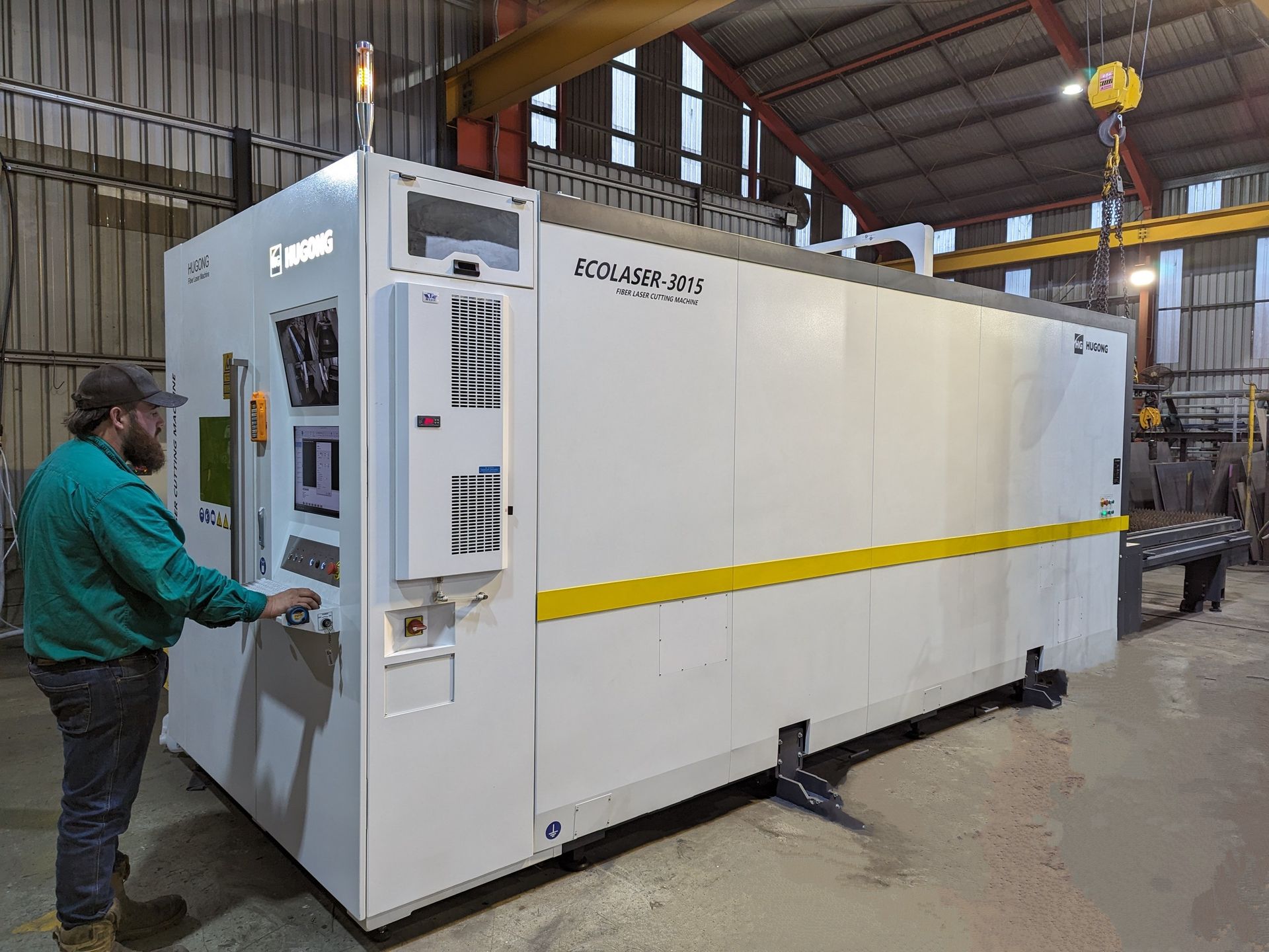 A Large White Machine Is Sitting in A Warehouse — Eddies Trailers & Fab in Muswellbrook, NSW