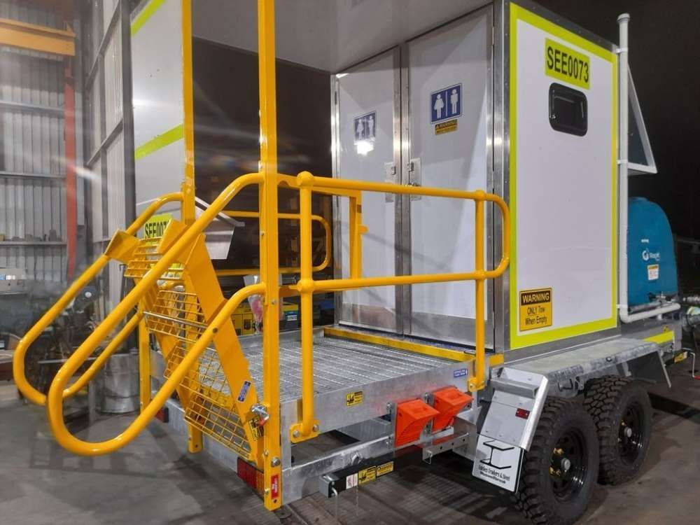 A Trailer With Stairs And A Yellow Railing Is Parked In A Warehouse — Eddies Trailers & Fab in Muswellbrook, NSW