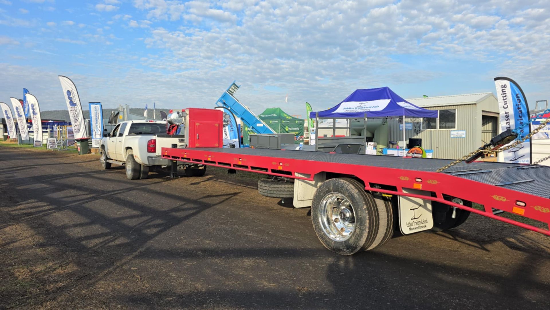 A red flatbed tow truck is parked on the side of the road.