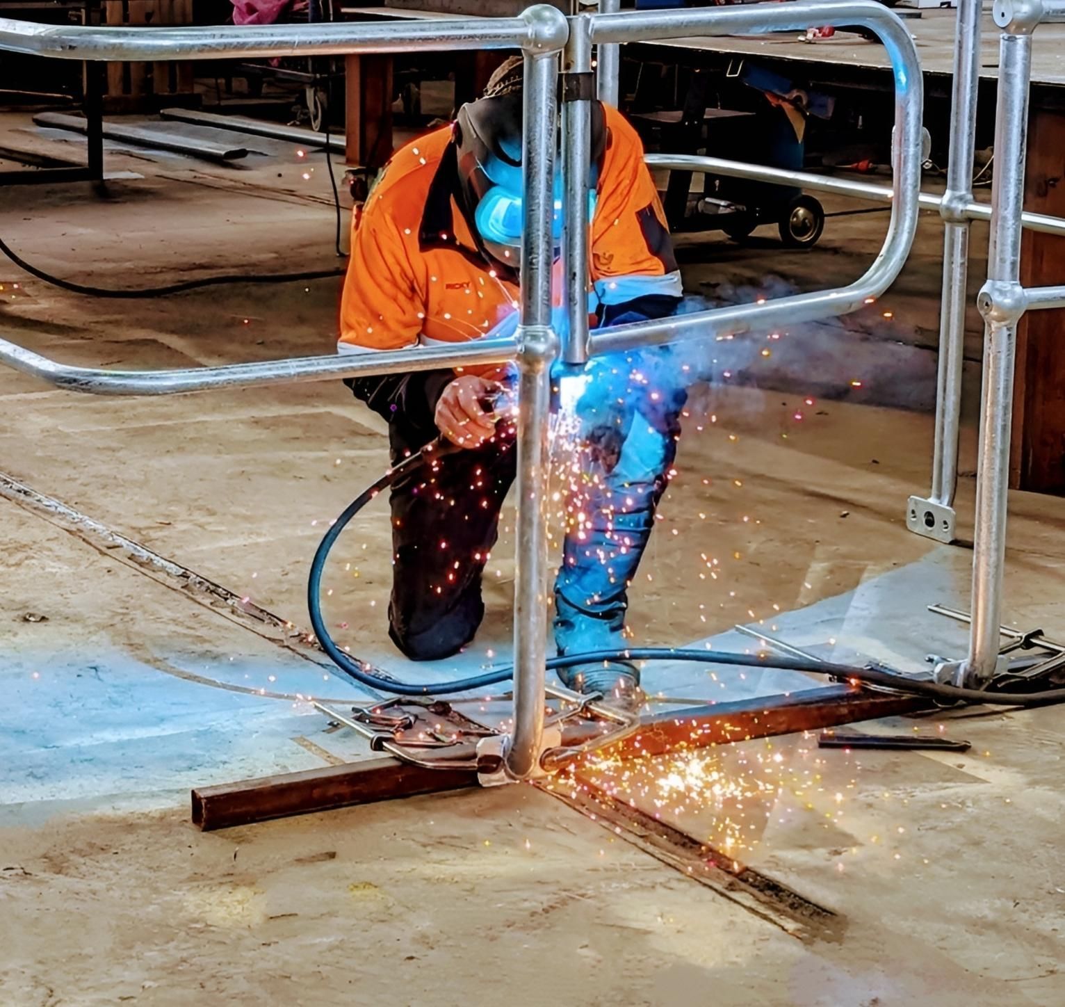 A Man Is Working on A Machine in A Factory — Eddies Trailers & Fab in Muswellbrook, NSW