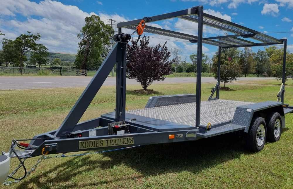 A Trailer Is Parked In A Grassy Field With Trees — Eddies Trailers & Fab in Muswellbrook, NSW