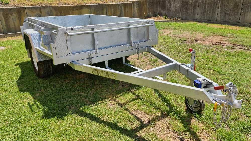 A Trailer Is Sitting On Top Of A Lush Green Field — Eddies Trailers & Fab in Muswellbrook, NSW