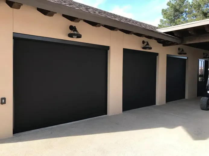 Three light-wood spice racks on a textured wall, next to a pantry with shelves of food.