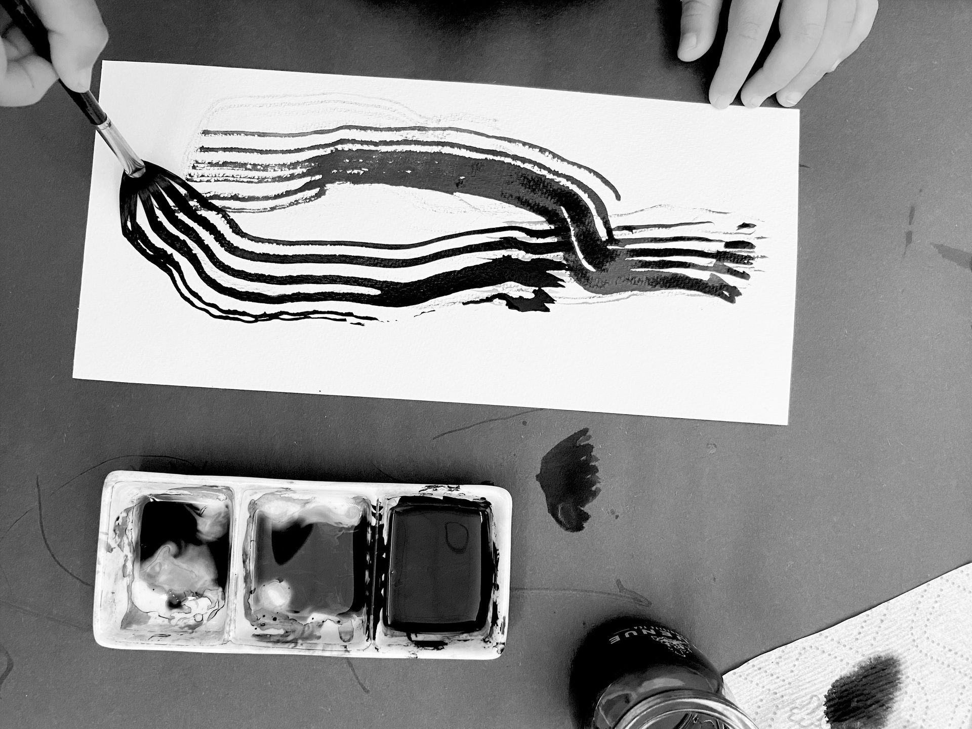 A group of children are sitting around a table with a teacher.