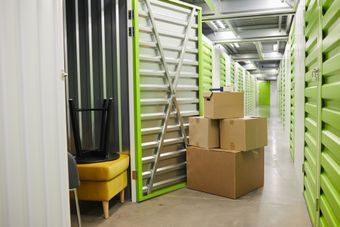 A row of cardboard boxes are stacked on top of each other in a storage room.