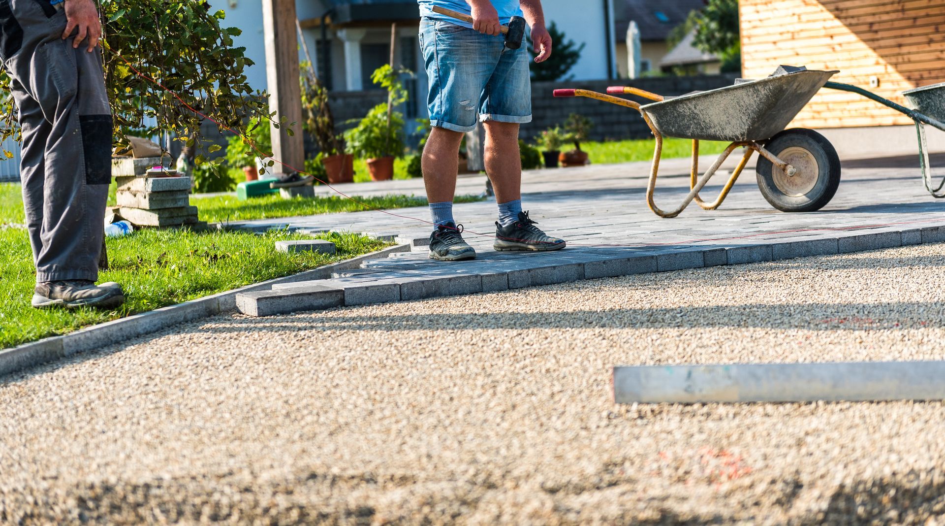 Workers are paving a driveway.
