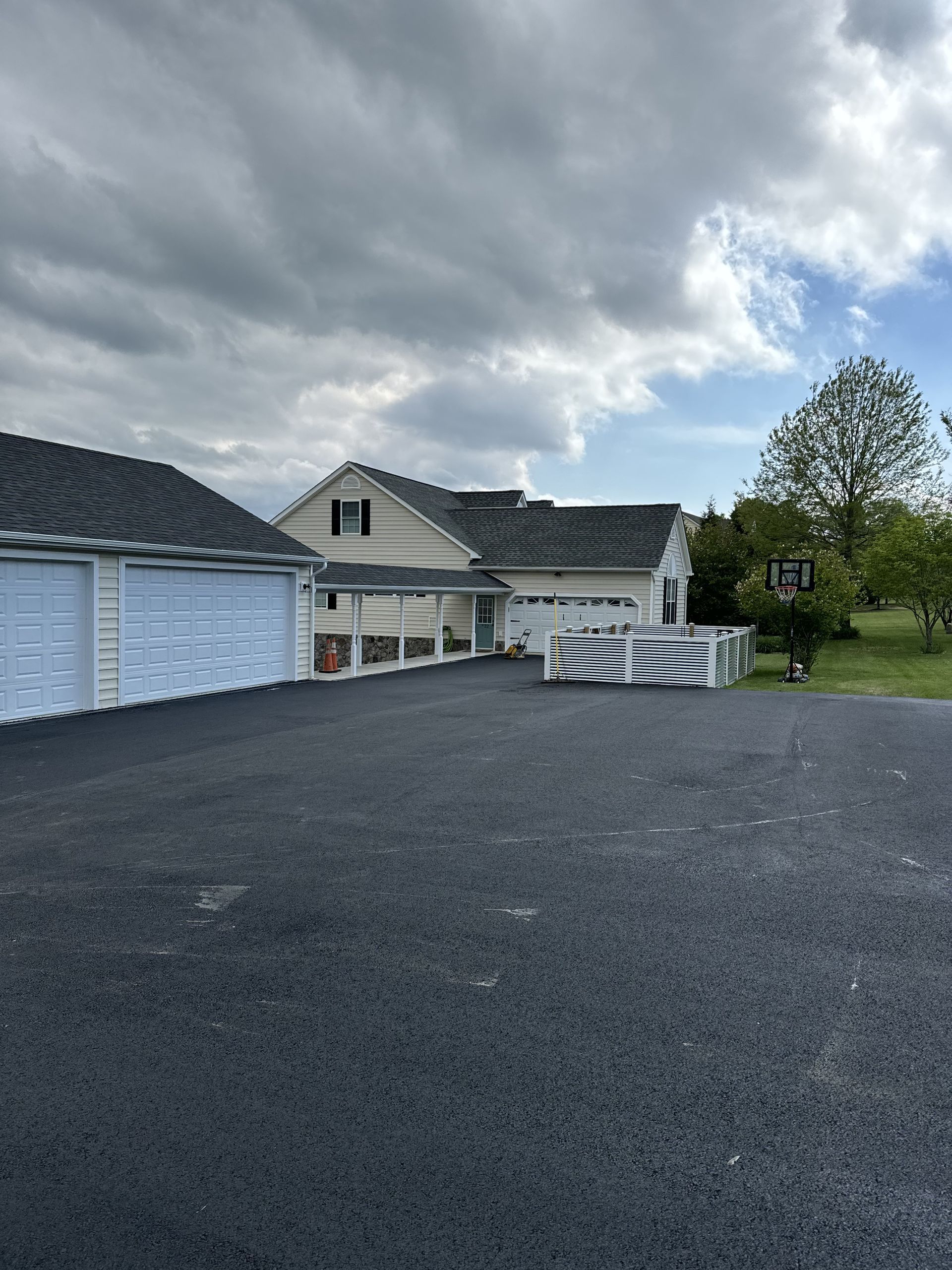 A large white house with a lot of garage doors