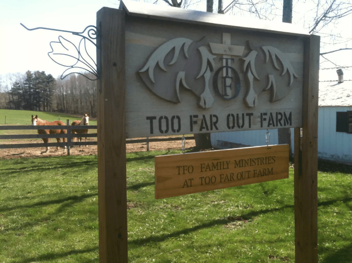 A sign that says too far out farm on it