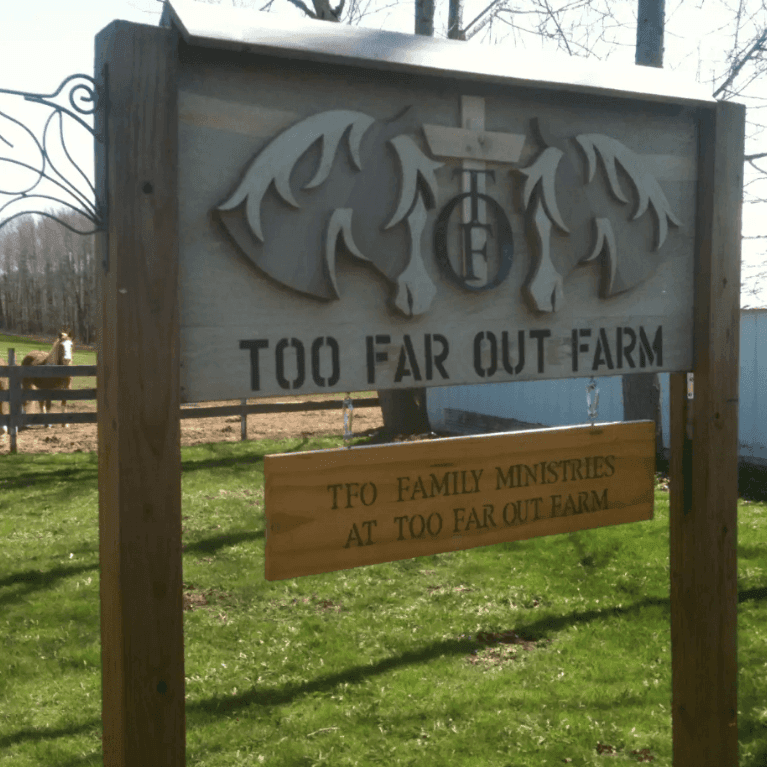 A sign that says too far out farm on it