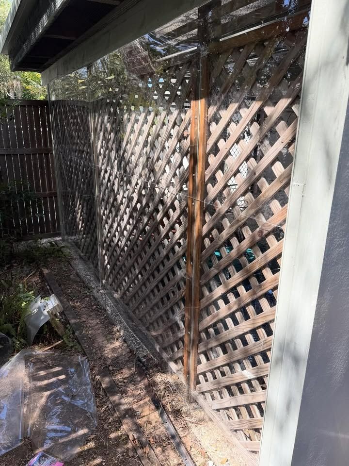 Wooden Lattice Fence Against a Building — RAC Carpentry Services in Pimpama, QLD