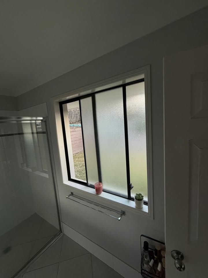Bathroom With a Frosted Glass Window — RAC Carpentry Services in Pimpama, QLD