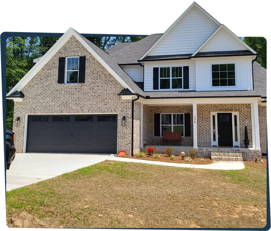 A large brick house with a black garage door