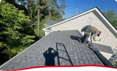 Two men are working on the roof of a house