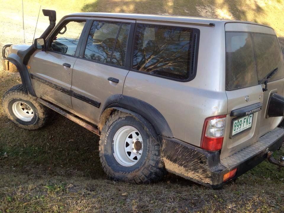 A Dirty Suv is Parked on a Grassy Field — Mr Shiny Mechanical in Sarina, QLD