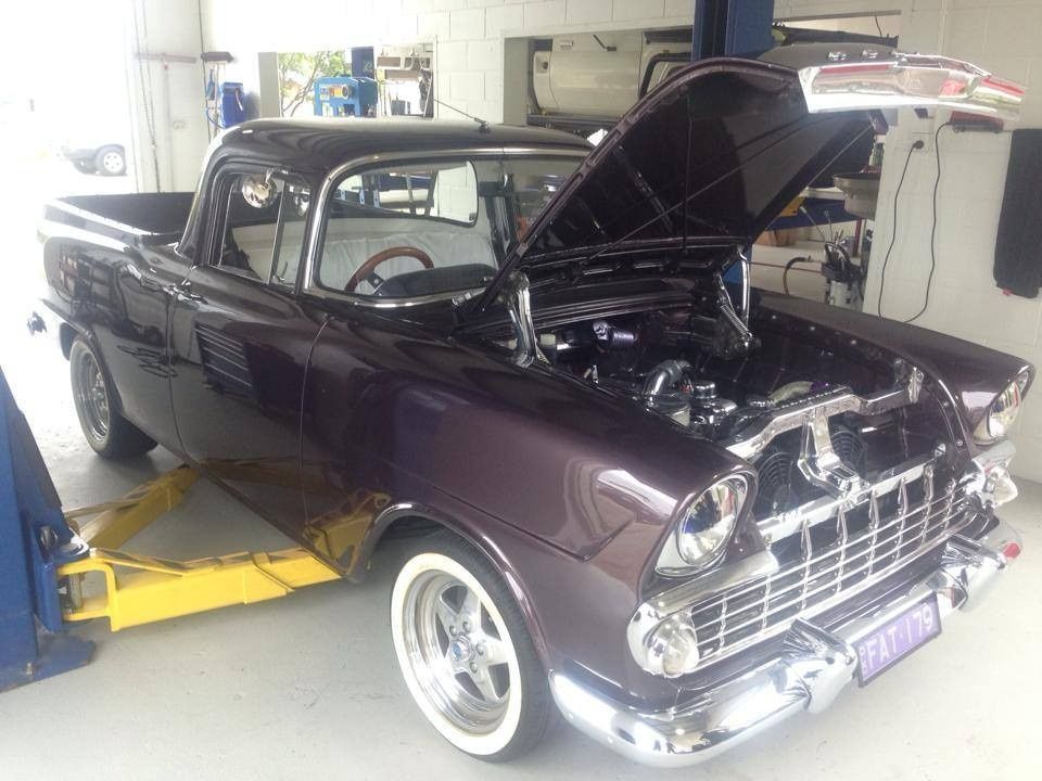 A Purple Truck With the Hood Up is on a Lift in a Garage — Mr Shiny Mechanical in Northern Beaches, QLD