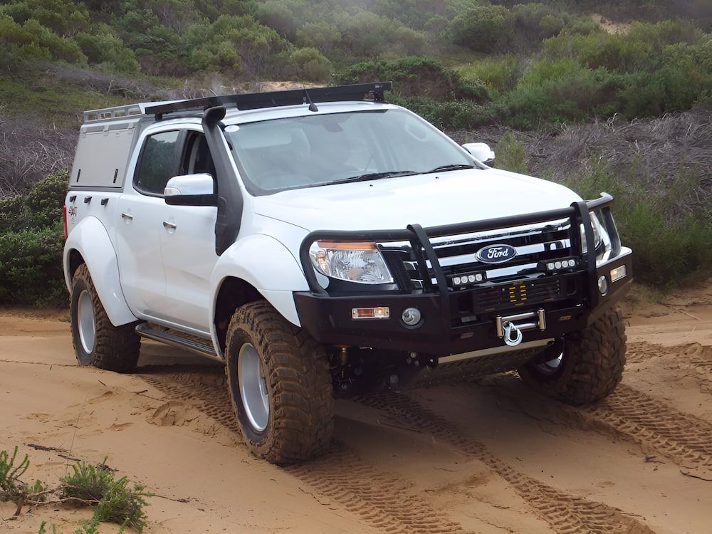 A White Truck With a Snorkel is Driving Down a Dirt Road — Mr Shiny Mechanical in Andergrove, QLD
