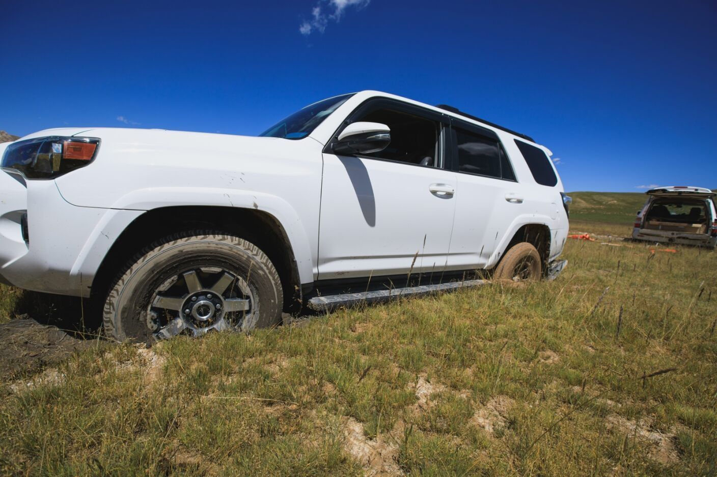 A White Suv is Parked on Top of a Grassy Hill — Mr Shiny Mechanical in Paget, QLD