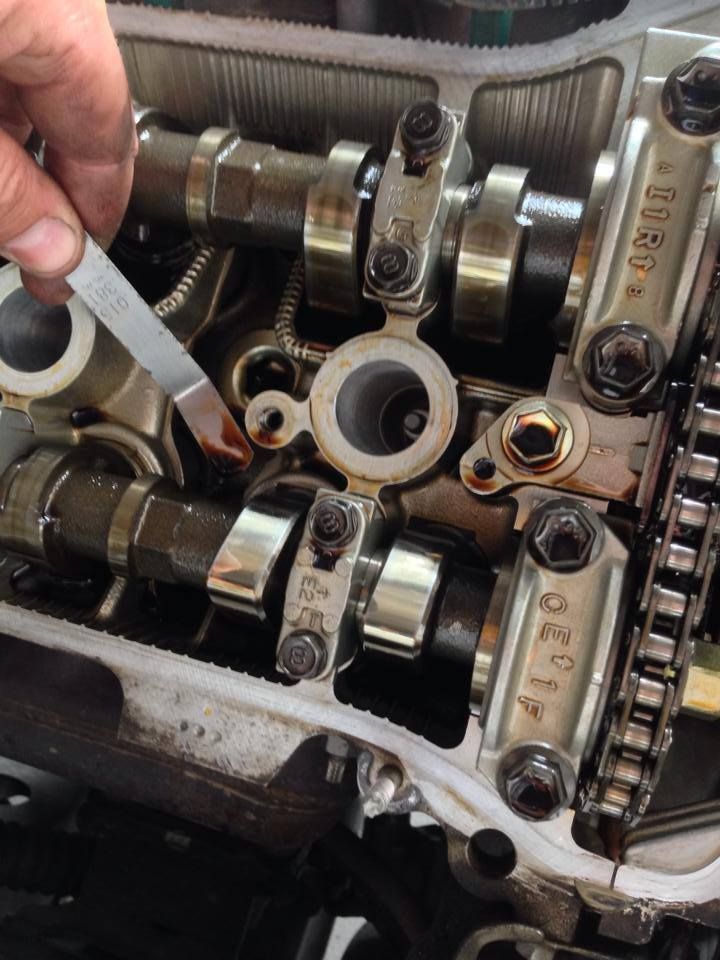 A Person is Working on a Car Engine With a Wrench — Mr Shiny Mechanical in Andergrove, QLD