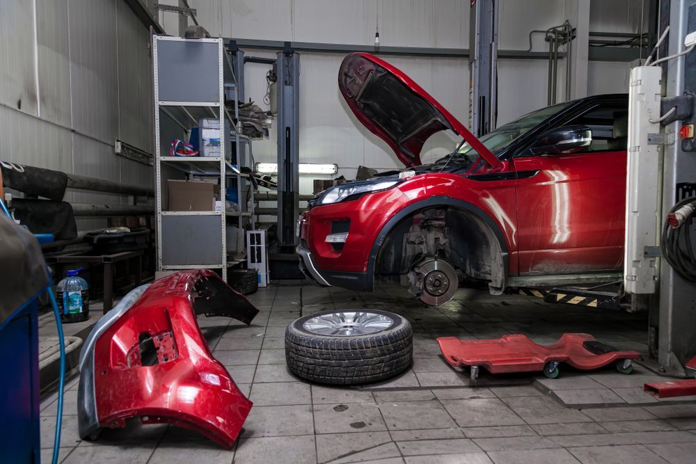 A Red Car is Parked in a Garage With Its Hood Open — Mr Shiny Mechanical in Paget, QLD