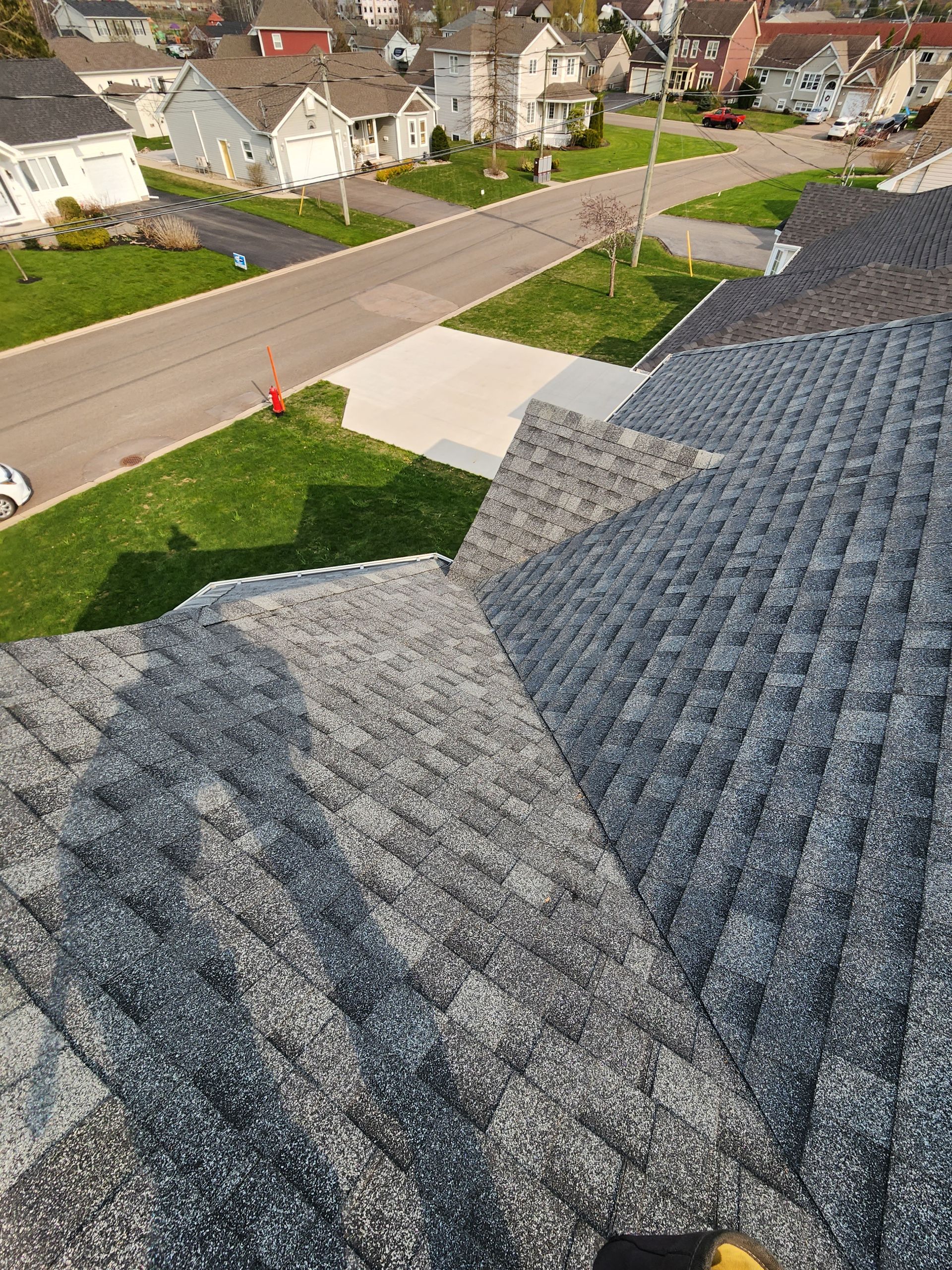 An aerial view of a roof in a residential neighborhood.