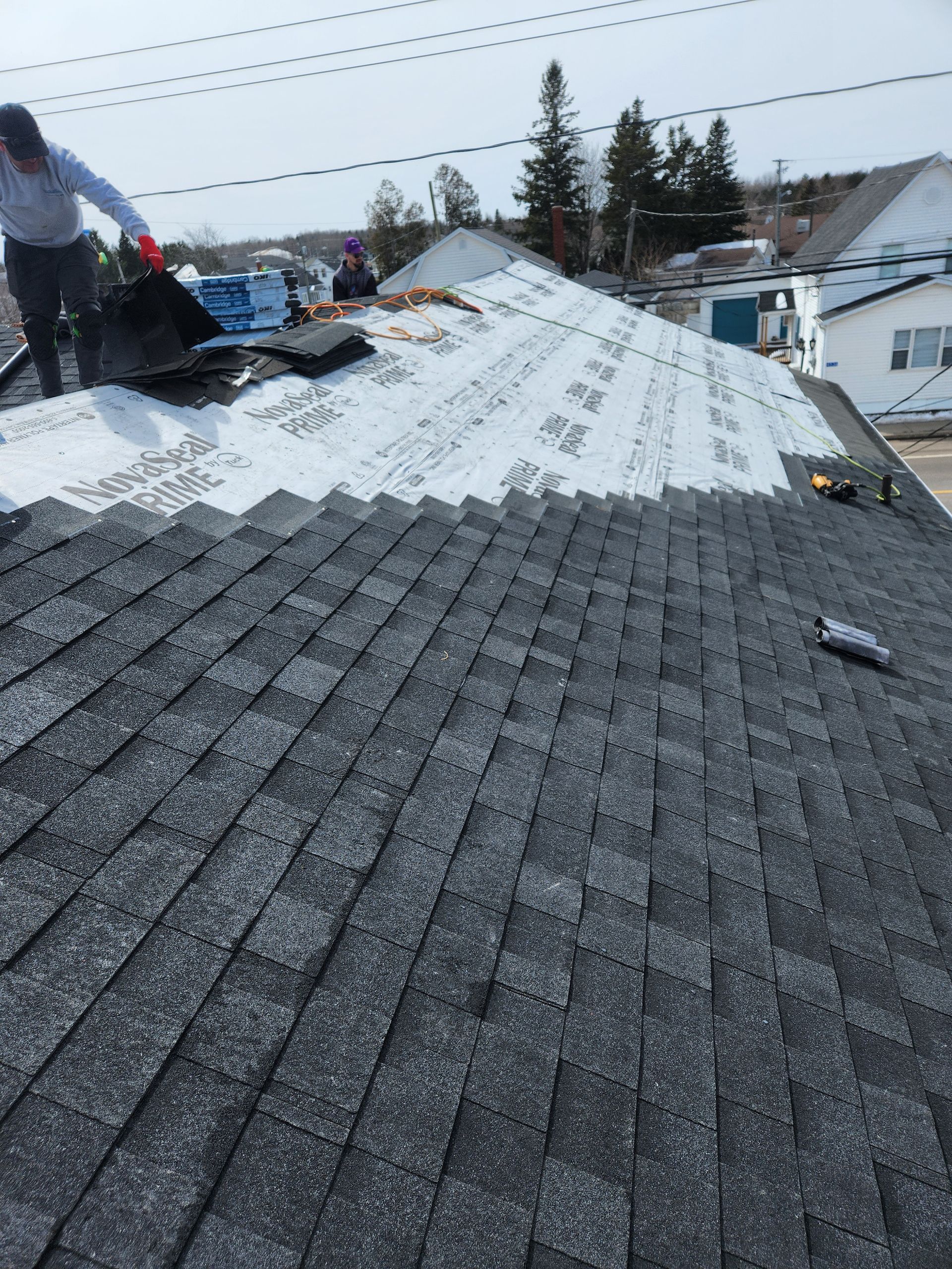 A man is working on the roof of a house
