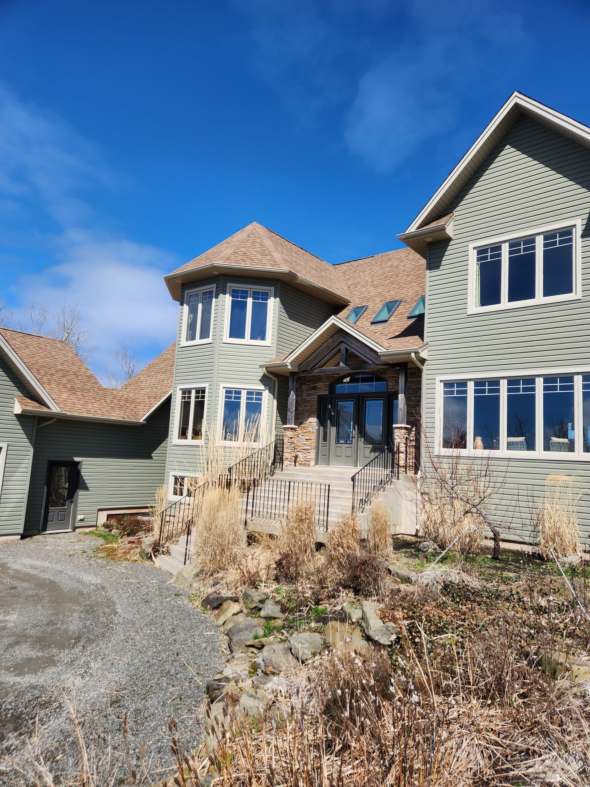 A large house with a lot of windows on a sunny day