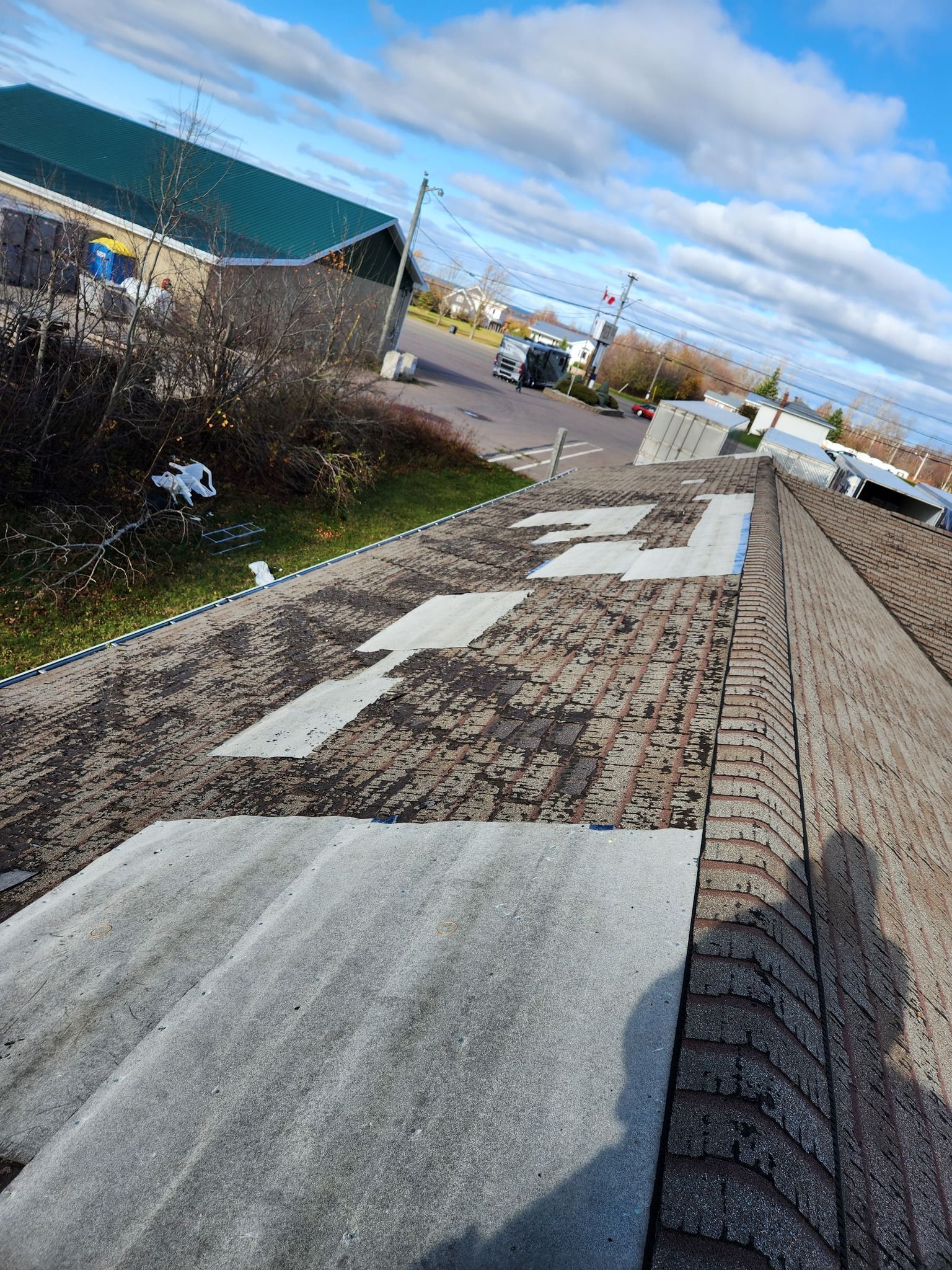 A close up of a roof with a shadow of a person on it.