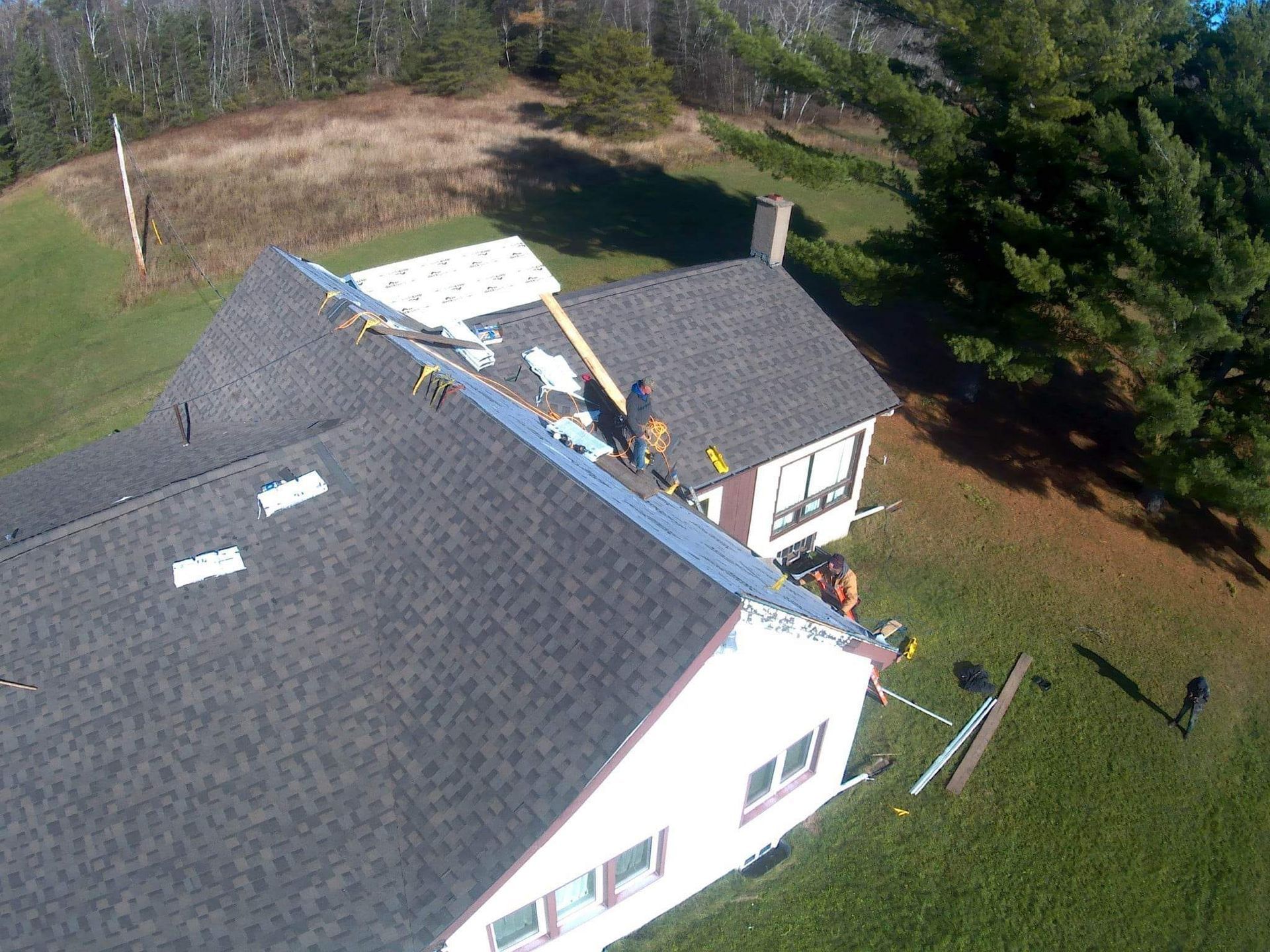 An aerial view of a house with a roof being installed.