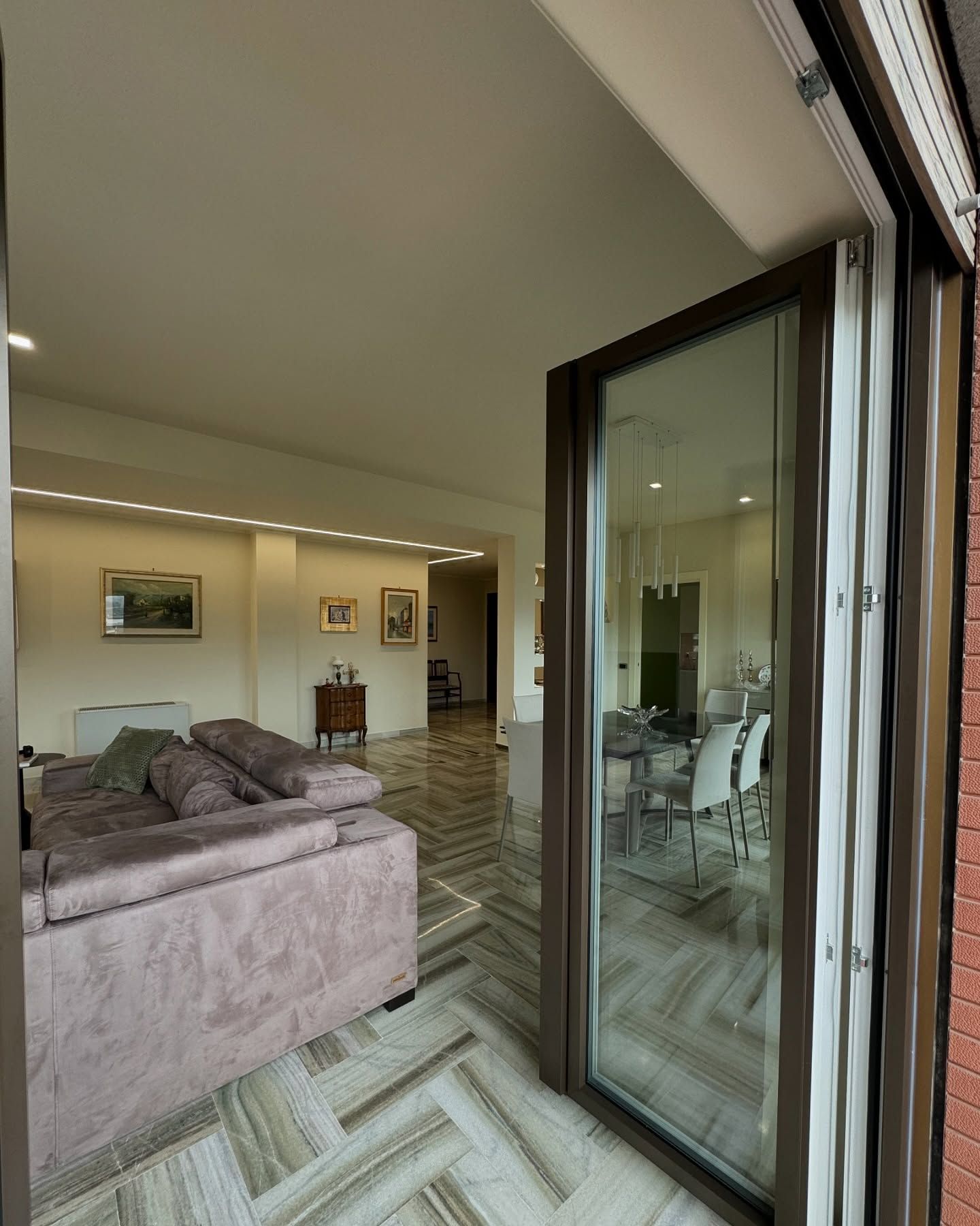 Un soggiorno con un divano e una porta scorrevole in vetro